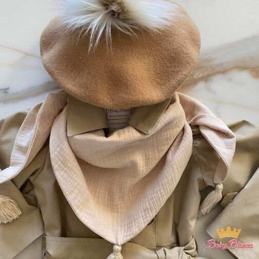 A beret with a fur pompom